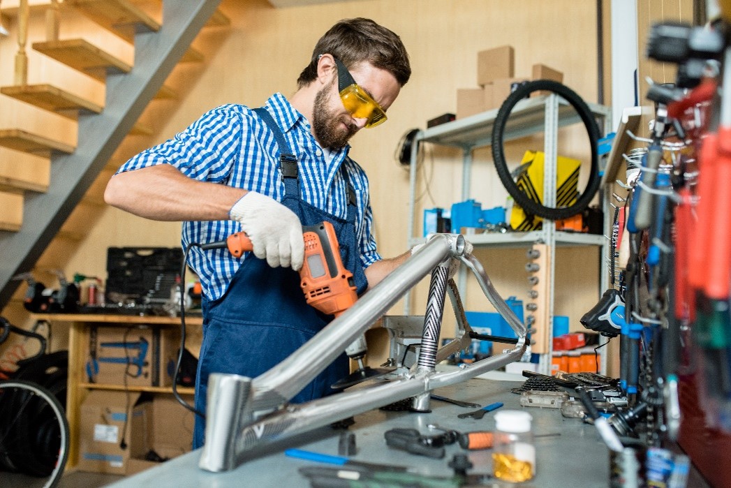 Workshop mechanic drilling metal frame